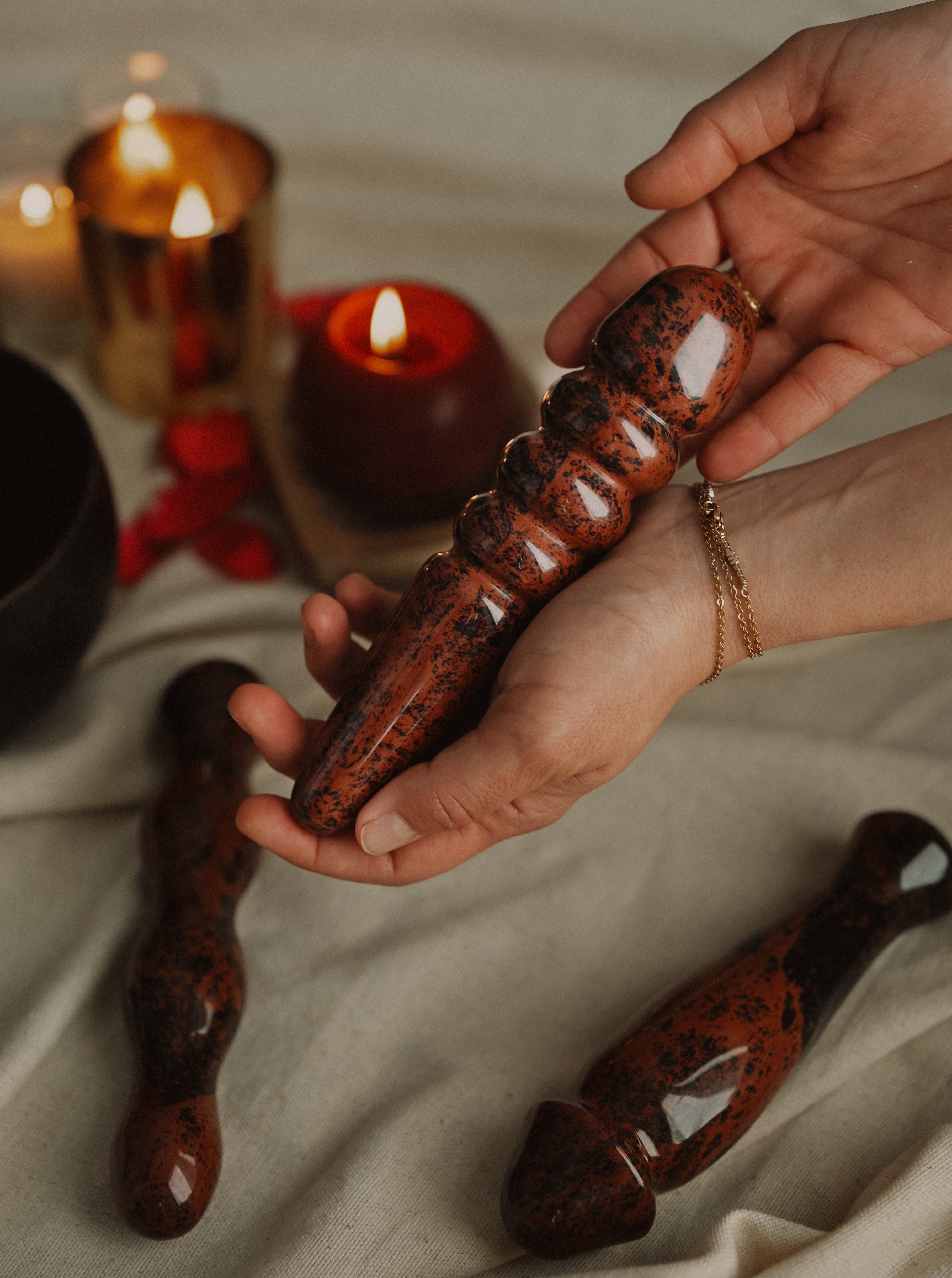 Chocolate truffles being held with candles in the background