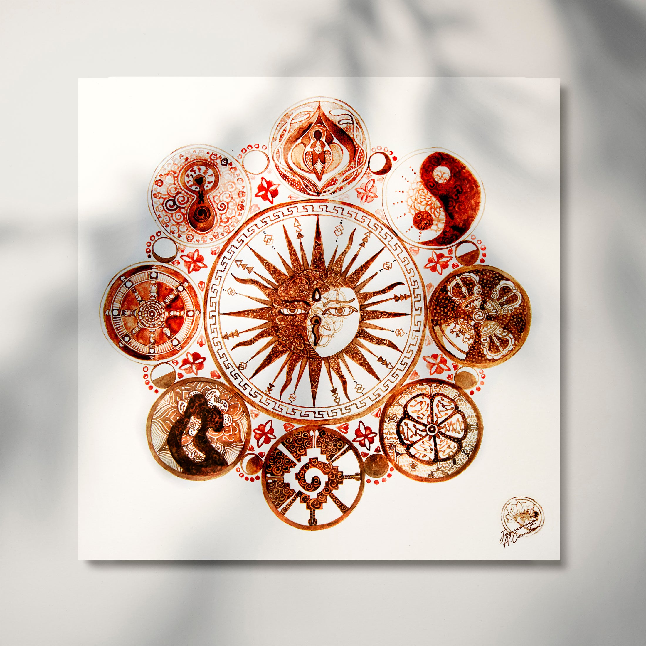 A printed artwork featuring a mandala-like design with elements such as a sun and moon in the center, surrounded by floral and geometric patterns, primarily in red and brown tones.