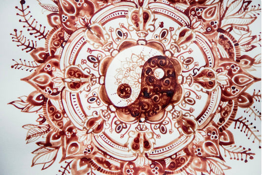 Decorative mandala with yin yang symbol in the center on a white background